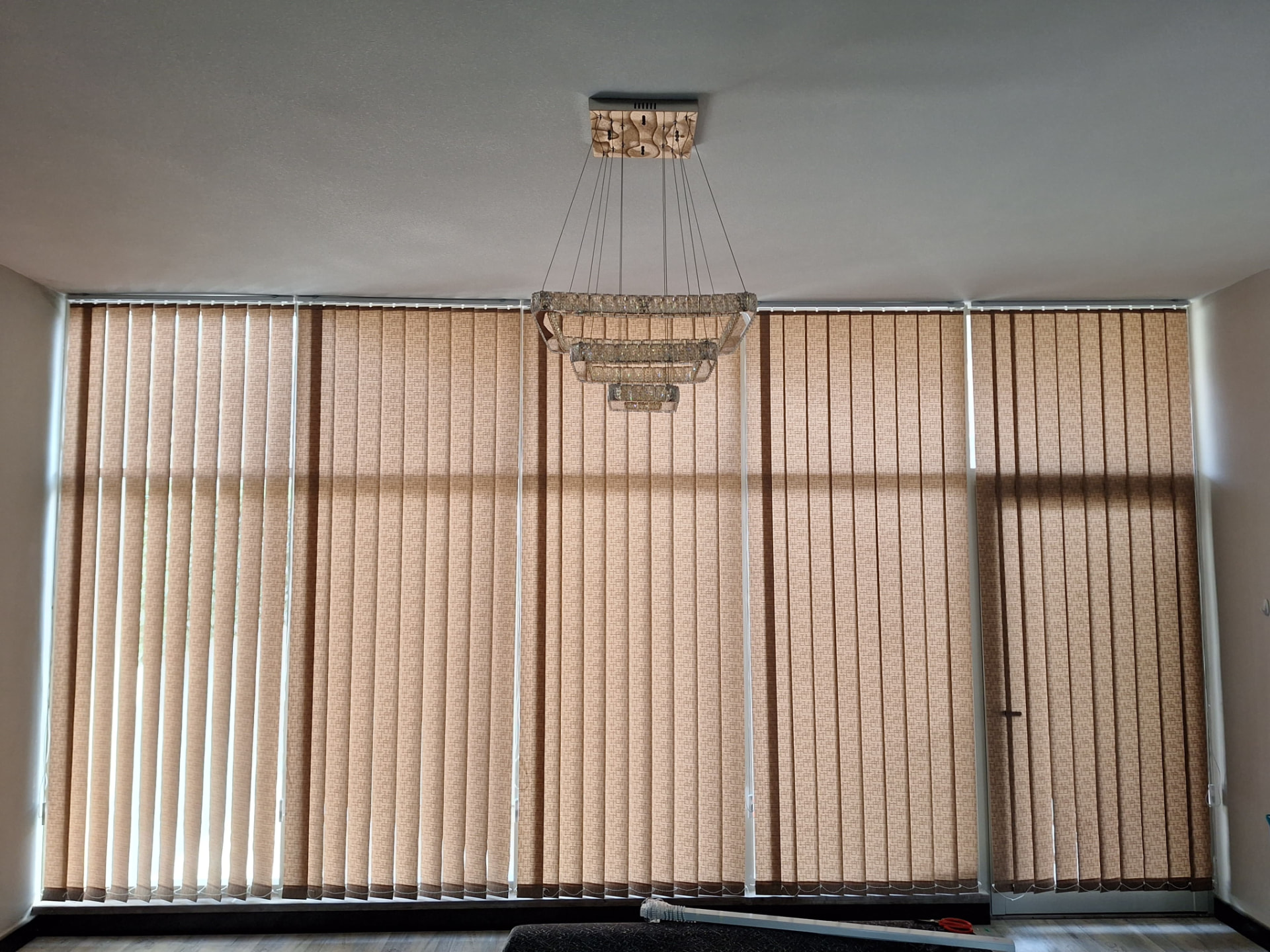 Vertical blinds across a wide living room window