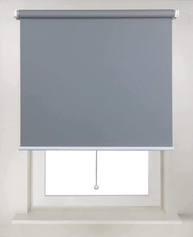Grey blackout roller blind fitted in a window recess