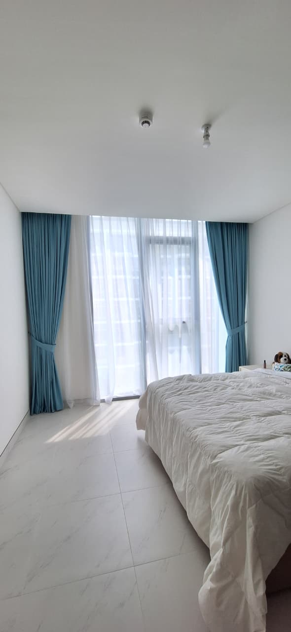 Teal bedroom curtains with tiebacks and sheer layer
